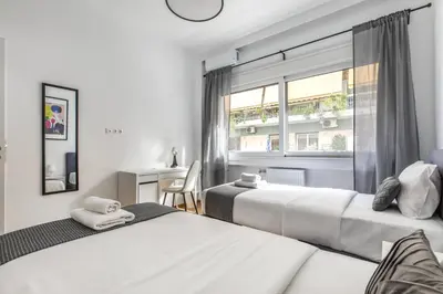 a bedroom with two beds and a window at Cozyopolis - Timeless 3-BR Escape in Athens in Athens