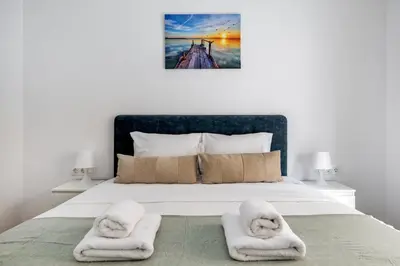 a bedroom with a bed with towels on it at Cozyopolis - Timeless 3-BR Escape in Athens in Athens
