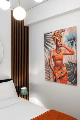 a painting of a woman hanging on a wall at Dema Luxury Suites - Romvis in Athens