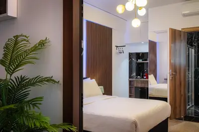 a bedroom with a bed and a plant at Dema Luxury Suites - Romvis in Athens