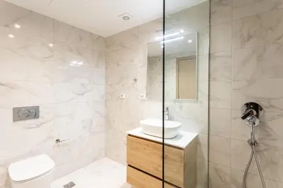a bathroom with a shower and a sink and a toilet at Grec Suites Dafni, Athens by GrecCollection in Athens