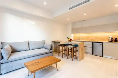 a living room with a couch and a table at Grec Suites Dafni, Athens by GrecCollection in Athens