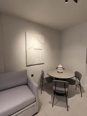a living room with a couch and a table at Shape Suites Athens in Athens