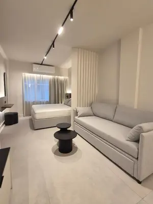a living room with a couch and a table at Shape Suites Athens in Athens