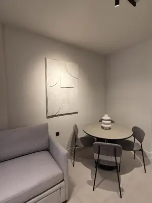 a living room with a couch and a table at Shape Suites Athens in Athens