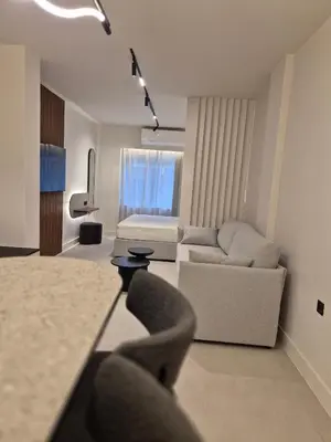 a living room with a couch and a living room with at Shape Suites Athens in Athens