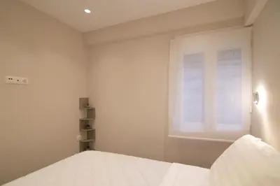 a bedroom with a bed and a window at Nafsika Cozy Flat B - Glyfada in Athens