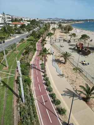 an aerial view of a road next to a beach at Nafsika Cozy Flat B - Glyfada in Athens