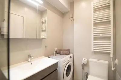 a white bathroom with a sink and a toilet at Nafsika Cozy Flat B - Glyfada in Athens