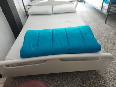 a hospital bed with a blue pillow on it at ACROPOLI AND MONASTIRAKI HOMe1 in Athens