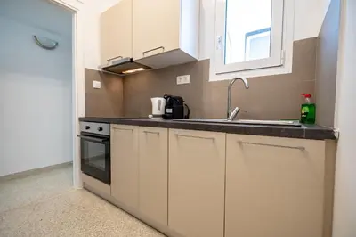 a kitchen with white cabinets and a sink at Casa di Anna 1 bed 4 pers Apt by MPS in Athens