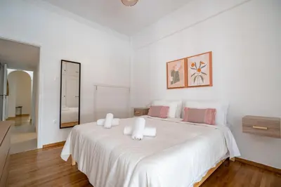 a white bedroom with a large white bed at Casa di Anna 1 bed 4 pers Apt by MPS in Athens
