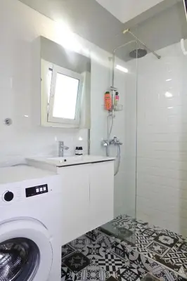 a bathroom with a washing machine and a sink at Casa di Anna 1 bed 4 pers Apt by MPS in Athens
