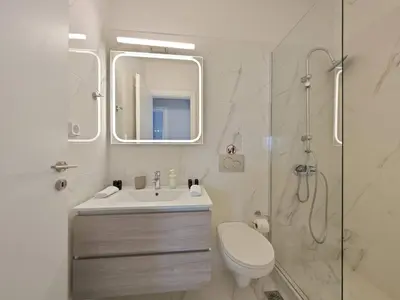 a bathroom with a toilet and a sink and a shower at Costa Voula Poolside and Beach, Home Cinema in Athens