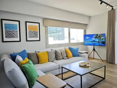 a living room with a couch and a table at Costa Voula Poolside and Beach, Home Cinema in Athens