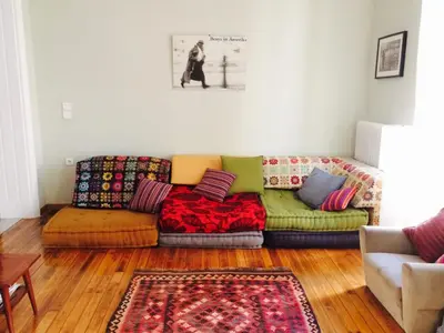 a living room with a couch with colorful pillows at Heritage house in Athens' heart in Athens