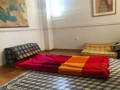 a bed sitting on the floor in a room at Heritage house in Athens' heart in Athens