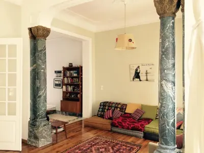 a living room with a couch and two columns at Heritage house in Athens' heart in Athens