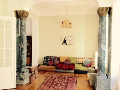 a living room with a couch and a rug at Heritage house in Athens' heart in Athens