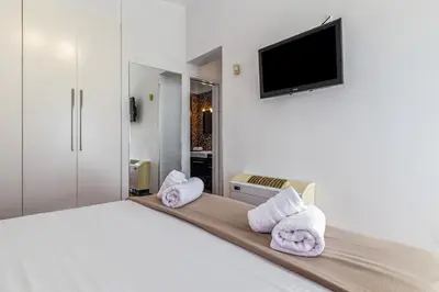 a bedroom with a bed with towels on it at Sea View Residence Panorama Villa in Saronida