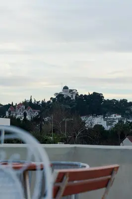 a balcony with a view of a house on a hill at Athens King 1 in Athens
