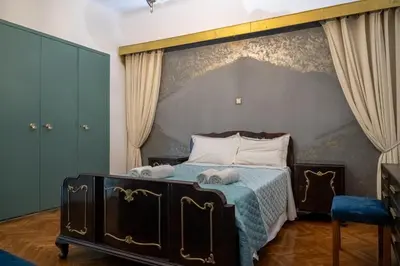 a bedroom with a bed with a large headboard at Athens King 1 in Athens