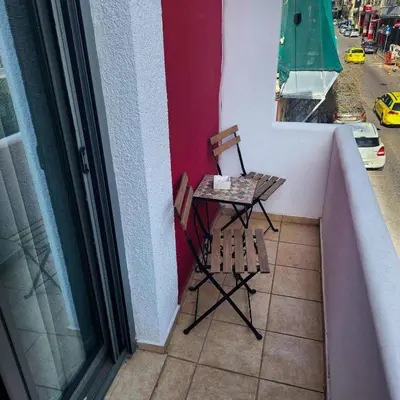 a small table and chair on a balcony at Athens King 1 in Athens
