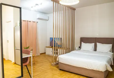 a bedroom with a large bed and a mirror at KASO - Vresthenis - Acropolis View in Athens