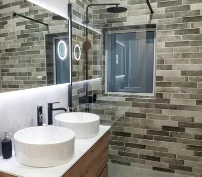 two sinks in a bathroom with a brick wall at KASO - Vresthenis - Acropolis View in Athens