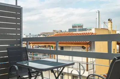 a balcony with a table and chairs on a building at KASO - Vresthenis - Acropolis View in Athens