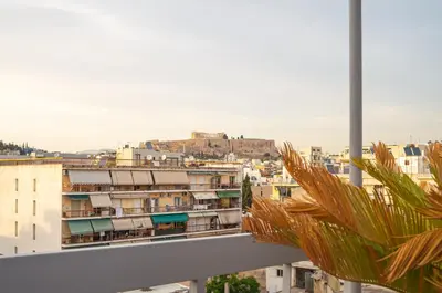 a view of a city from a balcony at KASO - Vresthenis - Acropolis View in Athens