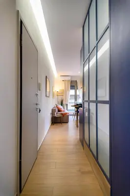 a hallway with a door leading to a living room at Daisy's Deluxe Athenian 2bedroom by MPS in Athens
