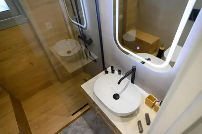 a bathroom with a sink and a shower at Daisy's Deluxe Athenian 2bedroom by MPS in Athens