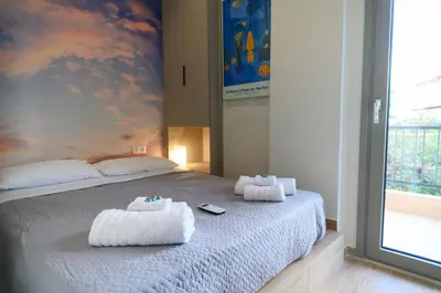 a bedroom with a bed with towels on it at Daisy's Deluxe Athenian 2bedroom by MPS in Athens
