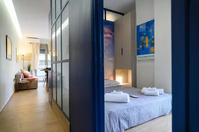 a bedroom with a bed with two towels on it at Daisy's Deluxe Athenian 2bedroom by MPS in Athens