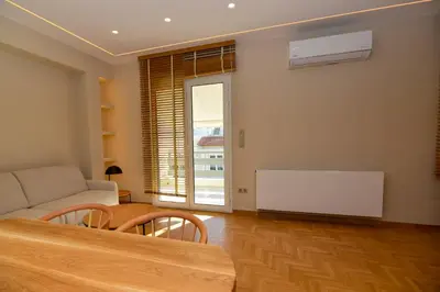 a living room with a couch and a table at Athens centre top floor stylish 2 min walk metro in Athens