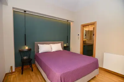 a bedroom with a purple bed in a room at Athens centre top floor stylish 2 min walk metro in Athens
