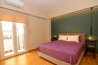 a bedroom with a bed with a large green wall at Athens centre top floor stylish 2 min walk metro in Athens