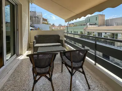 a balcony with two chairs and a table and a couch at Athens centre top floor stylish 2 min walk metro in Athens