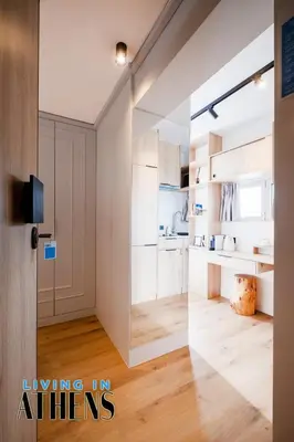 an open door into a living room with wood floors at Eugene's Loft - Acropolis View - Jacuzzi 2&1 ppl in Athens