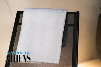 a pile of white towels sitting on a shelf at Eugene's Loft - Acropolis View - Jacuzzi 2&1 ppl in Athens