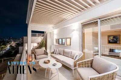 a living room with couches and a table on a balcony at Eugene's Loft - Acropolis View - Jacuzzi 2&1 ppl in Athens