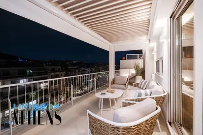 a balcony with white furniture and a view of the city at Eugene's Loft - Acropolis View - Jacuzzi 2&1 ppl in Athens