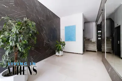 a hallway with two potted plants and a wall at Eugene's Loft - Acropolis View - Jacuzzi 2&1 ppl in Athens