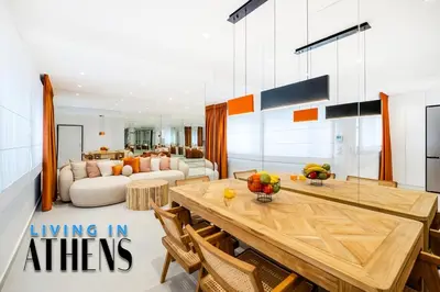 a living room with a table and a couch at Eugene's Luxury Apt 2&1 ppl 3min Walking Distance to Metro Station in Athens