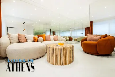 a living room with a couch and a table at Eugene's Luxury Apt 2&1 ppl 3min Walking Distance to Metro Station in Athens