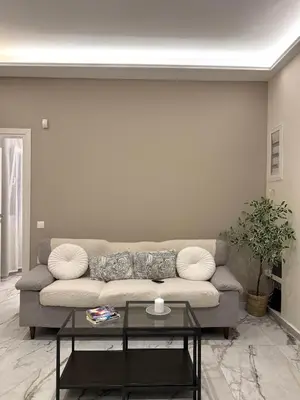 a living room with a couch and a table at Urban Luxy Staycation in Athens