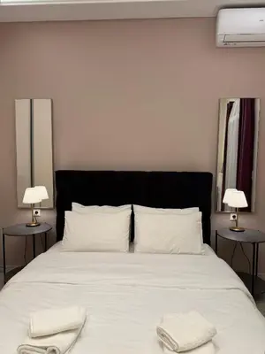 a bedroom with a large bed with two towels on it at Urban Luxy Staycation in Athens
