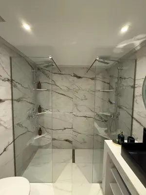 a bathroom with a shower with a glass door at Urban Luxy Staycation in Athens