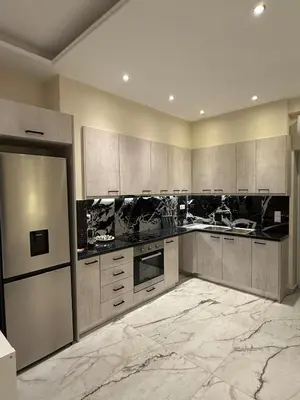 a large kitchen with stainless steel appliances and marble floors at Urban Luxy Staycation in Athens